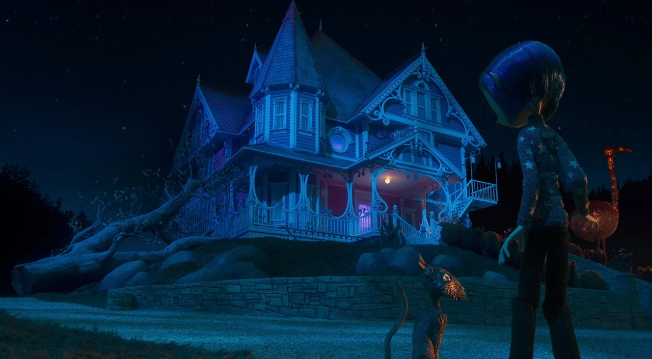 Coraline (2009) movie still: wide — A dark blue Victorian mansion stands on a raised hill under a starry sky. A young girl and a black cat watch the…