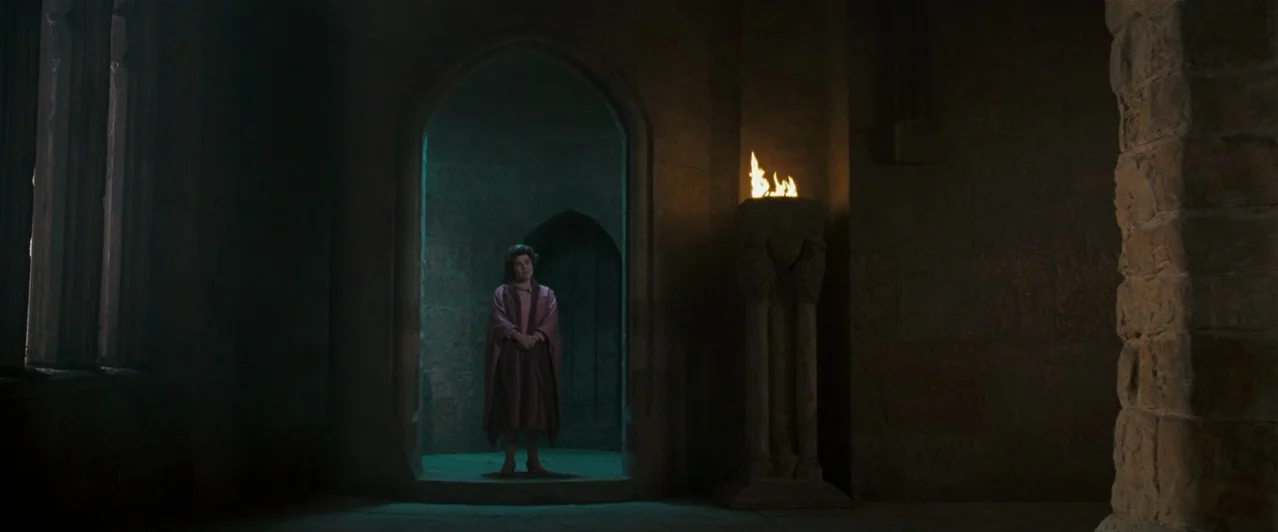 Harry Potter & The Order of the Phoenix (2007) movie still: fullbody — A dark stone room inside a castle features a prominent arched alcove with…