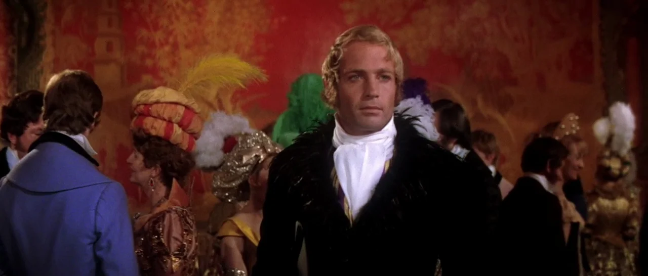 On A Clear Day You Can See Forever (1970) movie still: medium — A crowded 19th century ballroom features a vivid red patterned wall in the…