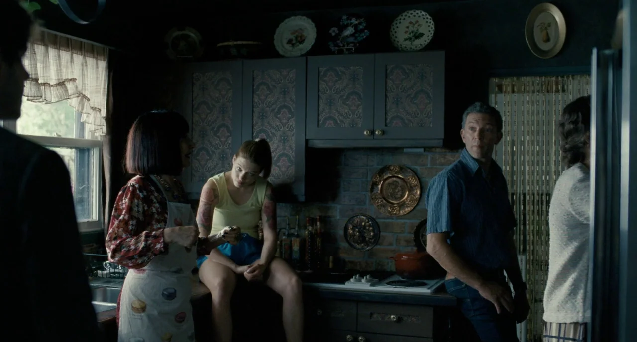 It’s Only The End Of The World (2016) movie still: medium — A residential setting features dark cabinetry with paisley inlays and decorative plates…