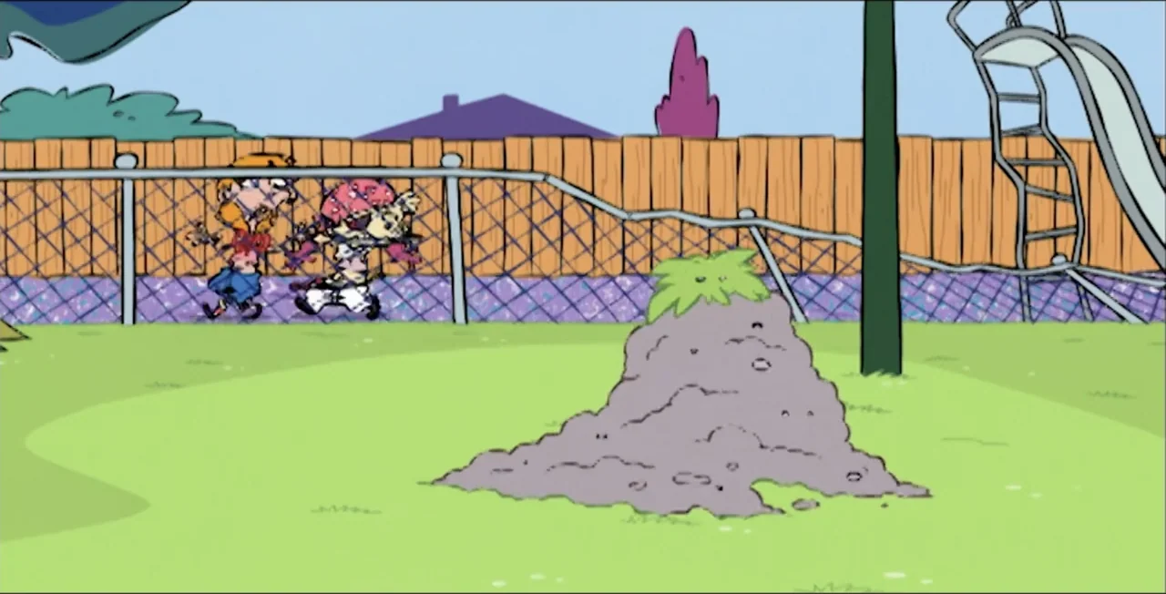 Ed, Edd n Eddy's Big Picture Show (2009) movie still: wide — A suburban backyard features a green lawn, a wooden fence, and a dirt mound. Two…