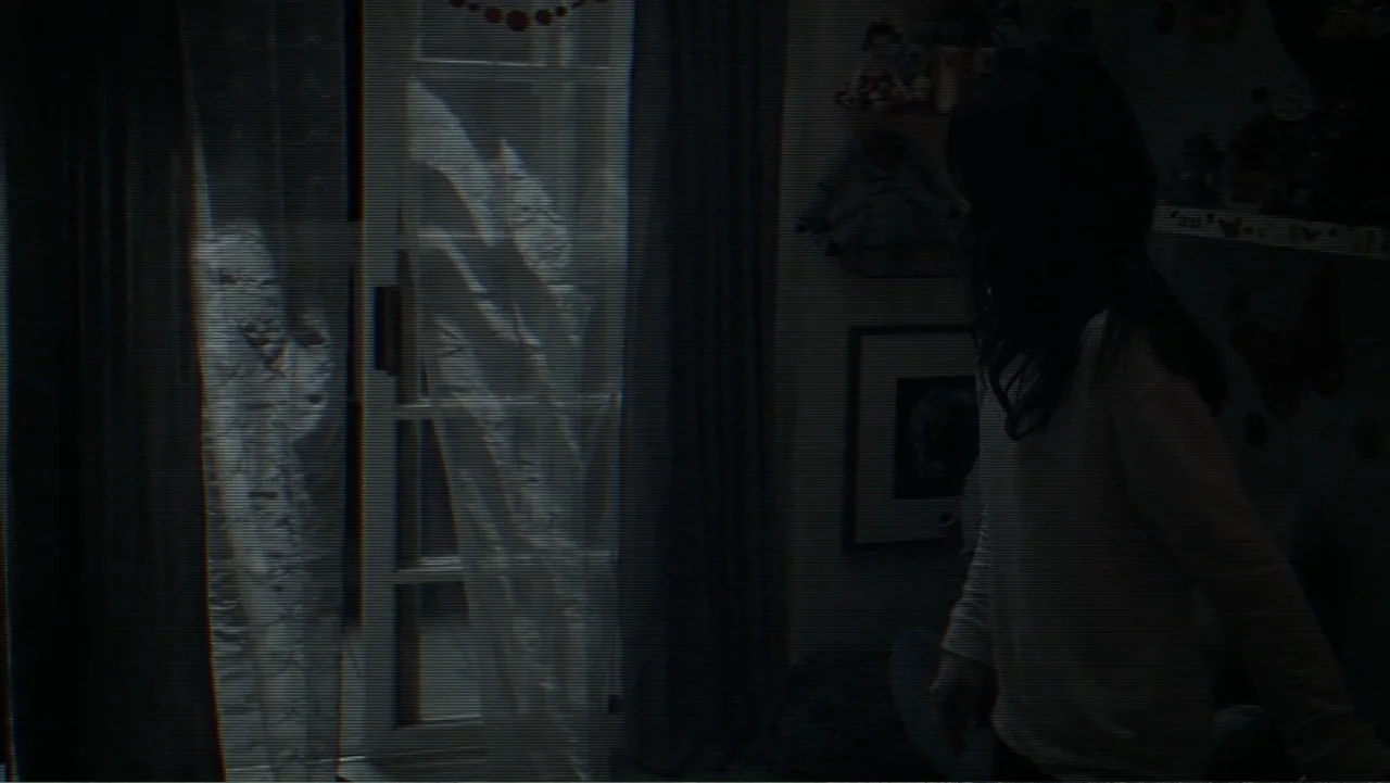 Paranormal Activity: The Ghost Dimension (2015) movie still: medium — A dark child's room features a window draped with translucent curtains under…