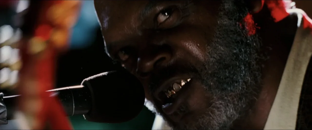 Black Snake Moan (2006) movie still: closeup — A dark, dimly lit environment features a microphone positioned directly in front of the subject. A…