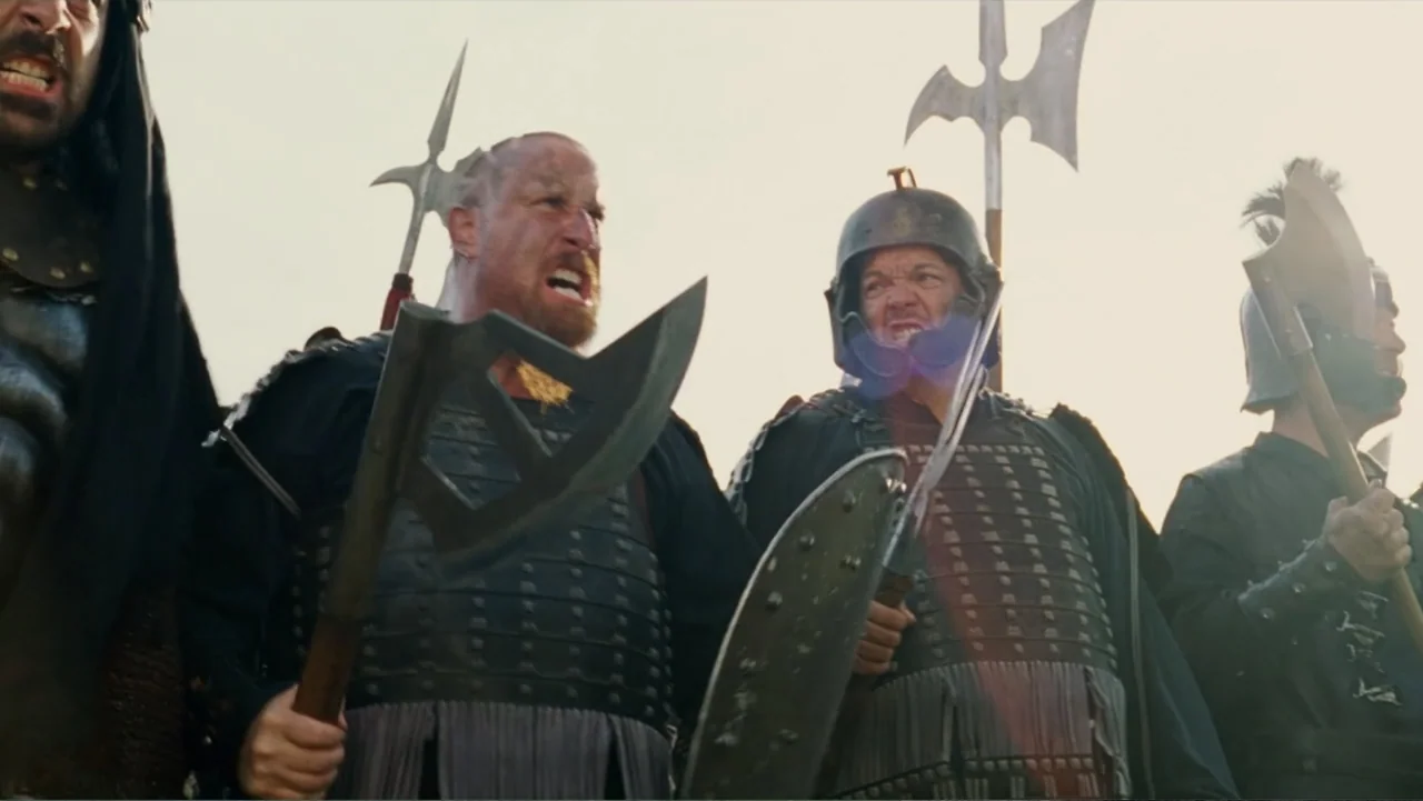 Epic Movie (2007) movie still: medium — A group of medieval soldiers stand on an open field during the day. Multiple armed warriors in dark armor…
