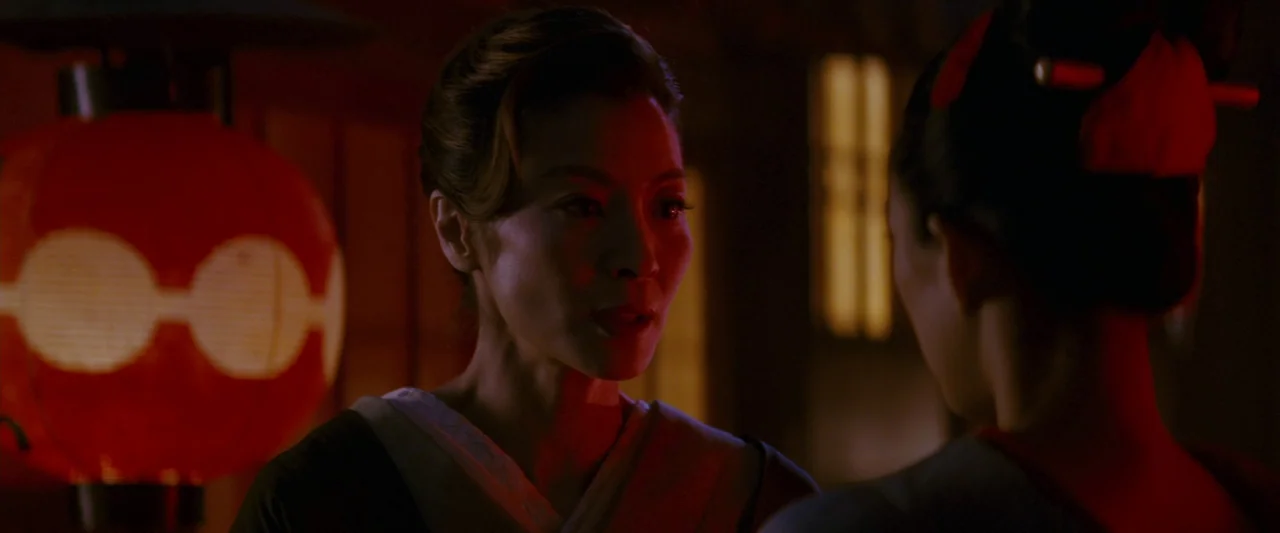 Memoirs of a Geisha (2005) movie still: medium — An interior space features warm light filtering through decorative red paper lanterns. A woman…