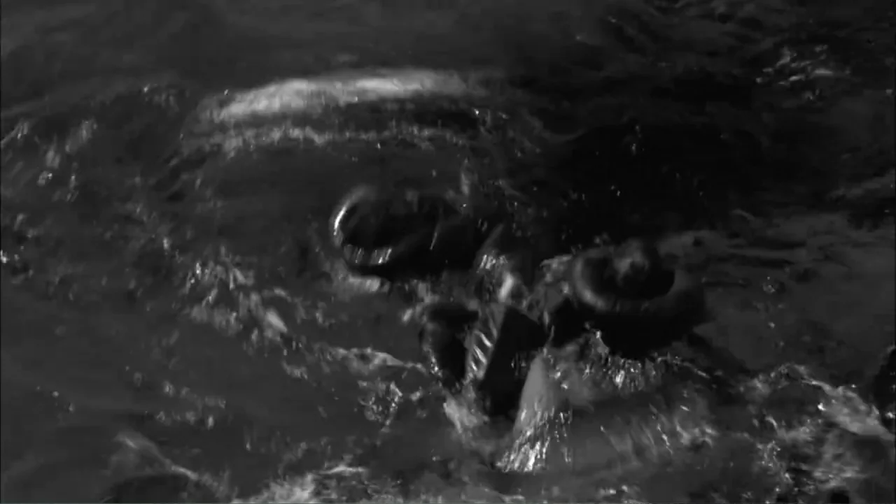Serial Killer: Red Sea Attacks (2023) movie still: medium — A dark, rippling body of water fills the entire frame. A human figure is partially…