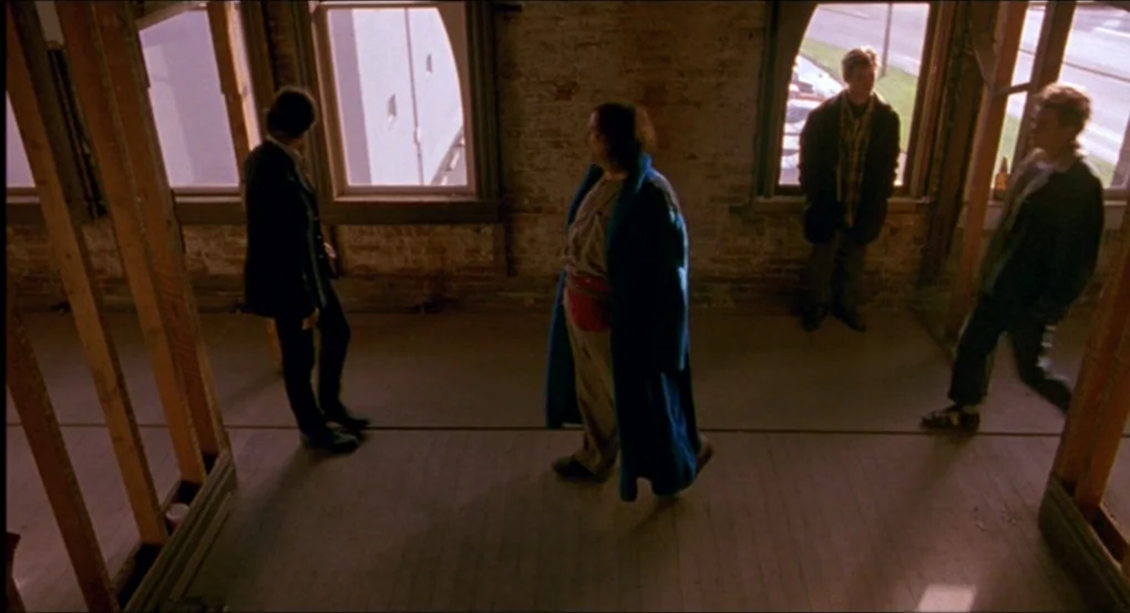 My Own Private Idaho (1991) movie still: wide — An empty room features exposed brick walls and vertical wooden framing studs in construction. Four…