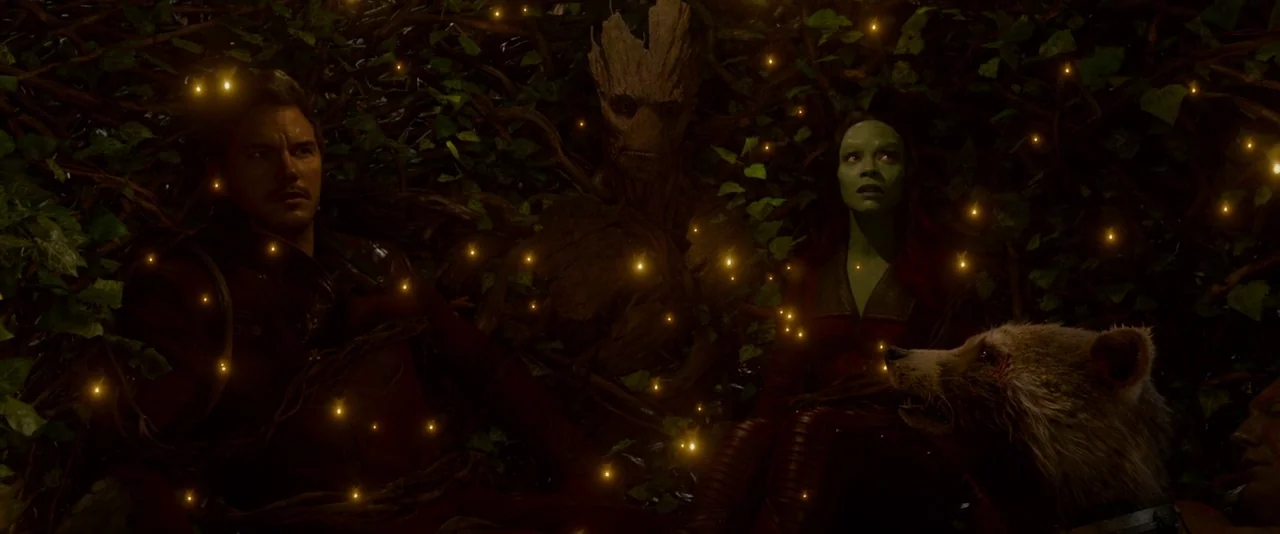 Guardians of the Galaxy (2014) movie still: medium — A group of four figures sits inside a tangle of thick, dark, knotted woody vines. They are…