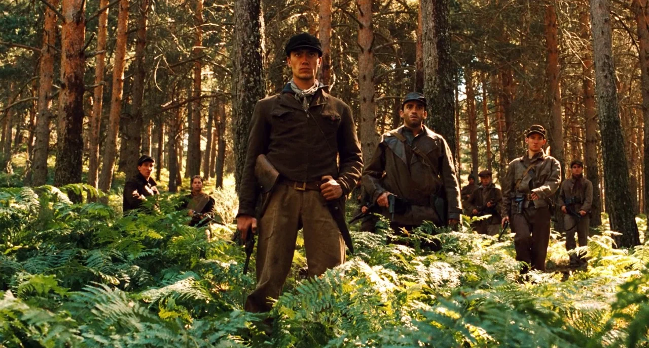 Pan’s Labyrinth (2006) movie still: fullbody — A group of soldiers move through a thicket of ferns in a pine forest. They wear mid-twentieth century…