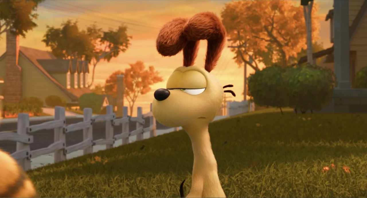 The Garfield Movie (2024) movie still: medium — A residential front lawn at sunset features a white wooden fence and autumnal trees. An…