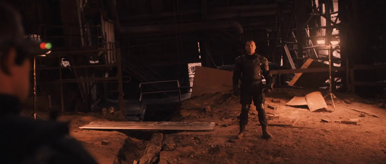 Universal Soldier: Regeneration (2009) movie still: wide — An industrial facility featuring exposed structural beams, loose debris, and uneven dirt…