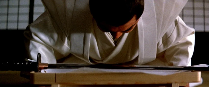 Lone Wolf and Cub: Sword of Vengeance (1972) movie still: closeup — A traditional room with shoji screens in the blurred background. A man kneels in…