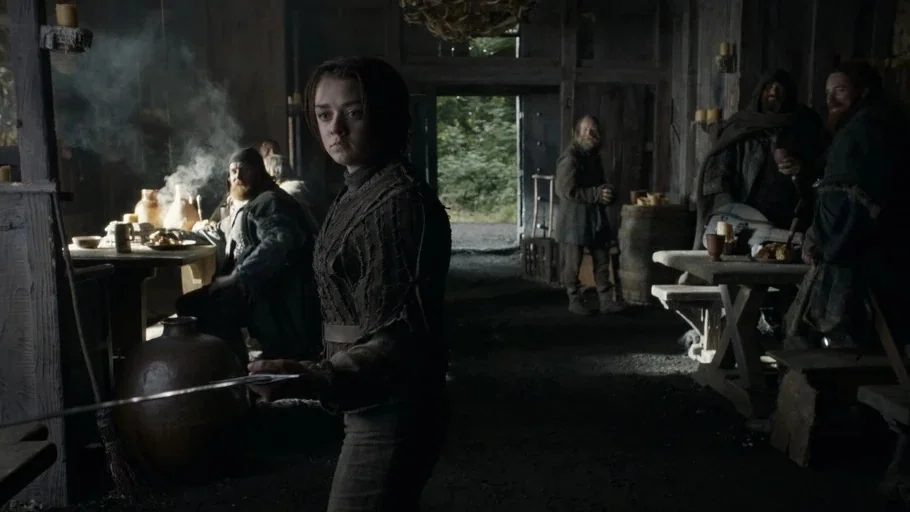 Game of Thrones: The Last Watch (2019) movie still: medium — A dimly lit, rustic wooden tavern interior with thick beams and earthen floors. A young…
