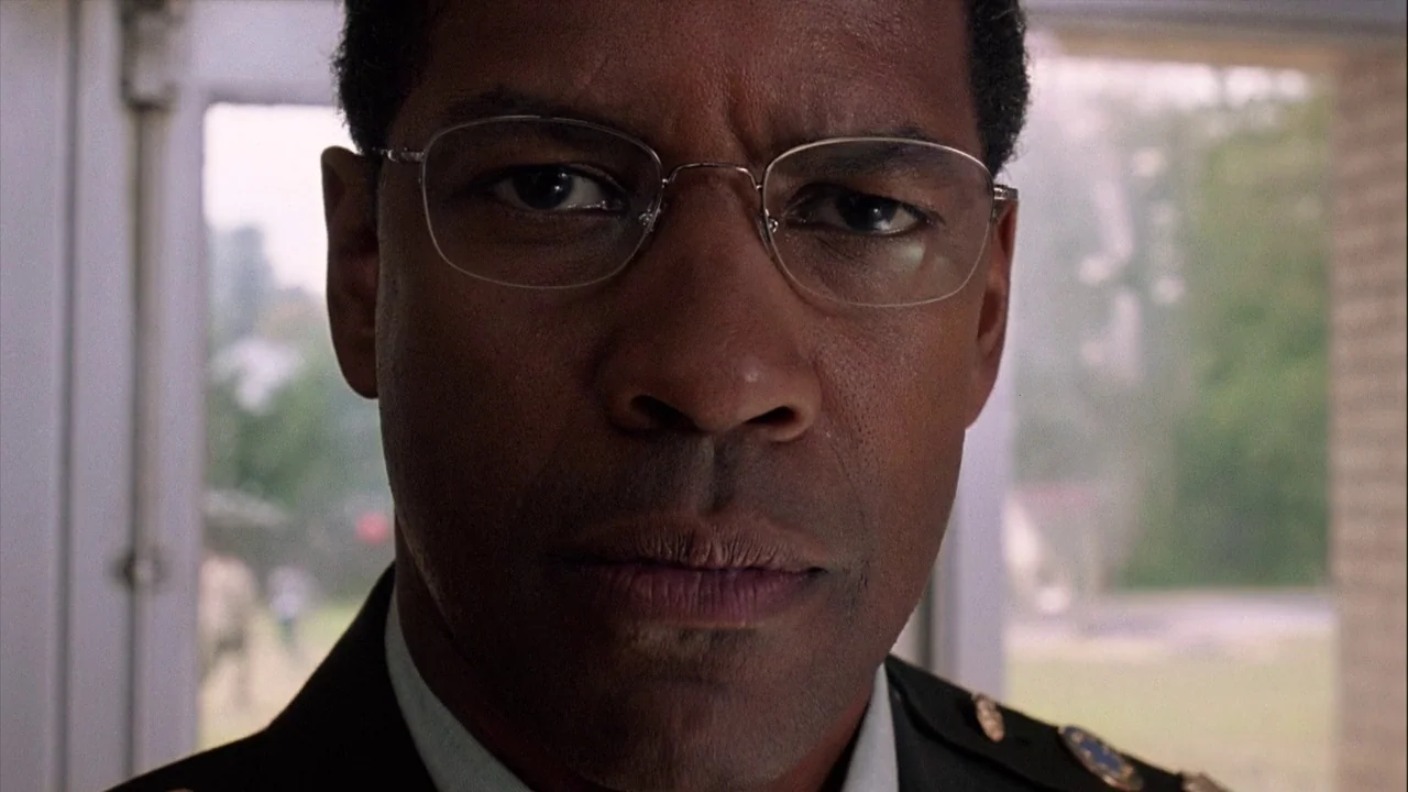 The Manchurian Candidate (2004) movie still: closeup — A man in a military uniform stands before a bright window. The subject faces the camera…