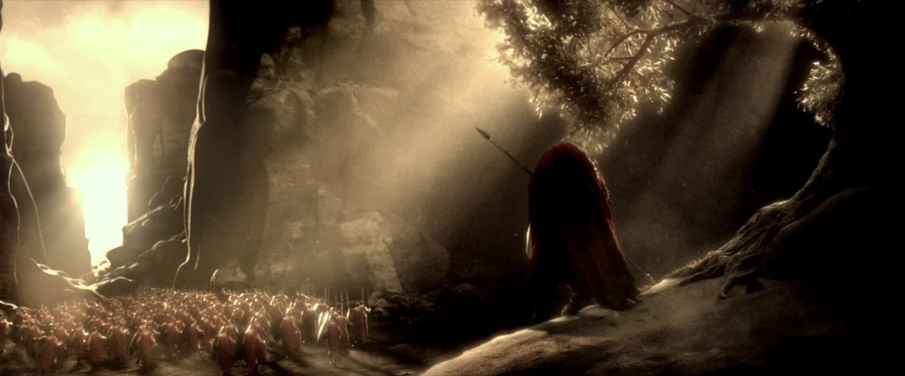 300: Rise of an Empire (2014) movie still: wide — A craggy mountain pass filled with dust and sunlight illuminating a vast landscape. A singular…