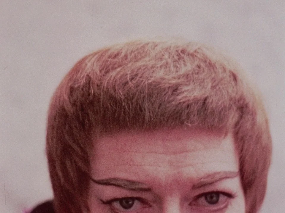The Wormwood Star (1956) movie still: closeup — A close-up studio portrait of a woman with a 1960s hairstyle and makeup. The subject is framed…