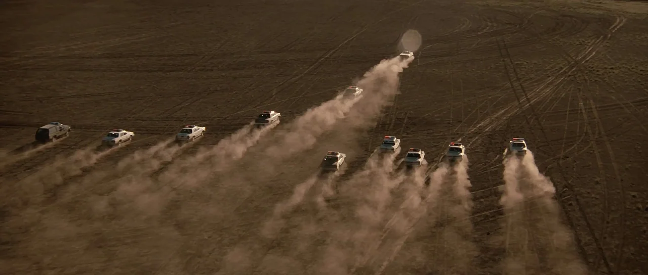 Thelma & Louise (1991) movie still: wide — A vast, flat desert basin features tire tracks imprinted into the dusty ground surface. Numerous white…