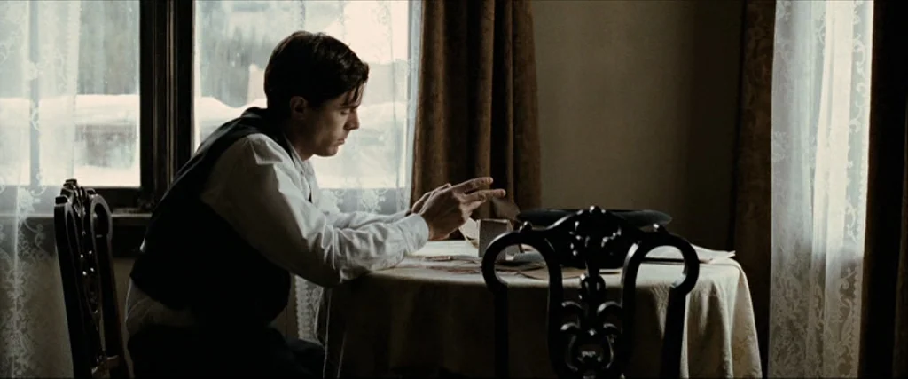 The Assassination Of Jesse James By The Coward Robert Ford (2007) movie still: medium — A small dining area features a round table covered with a…