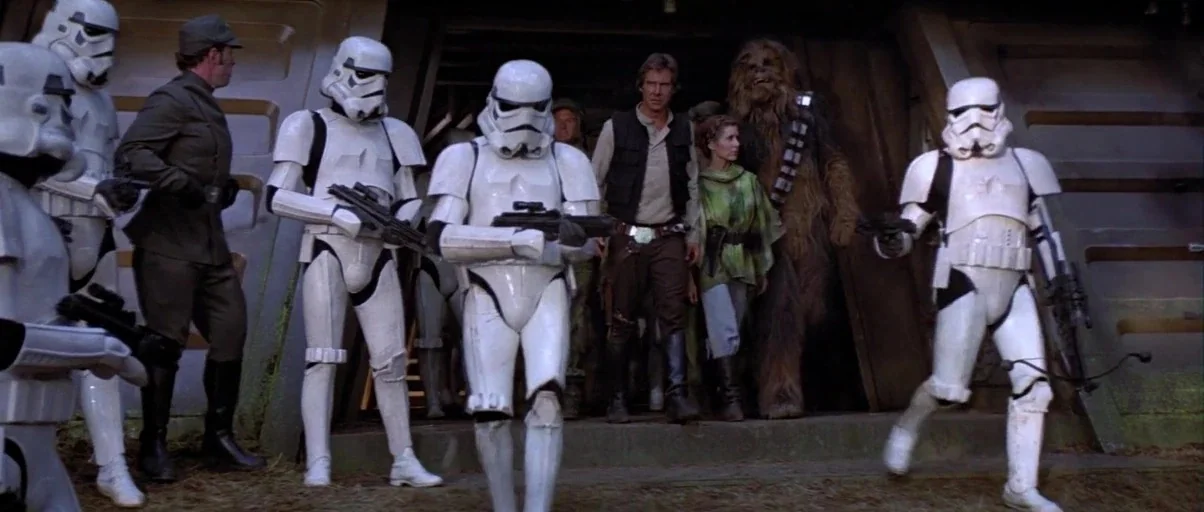 Return Of The Jedi (1983) movie still: fullbody — A metal bunker entrance built into an earthen mound sits in a forest clearing. Han Solo, Princess…