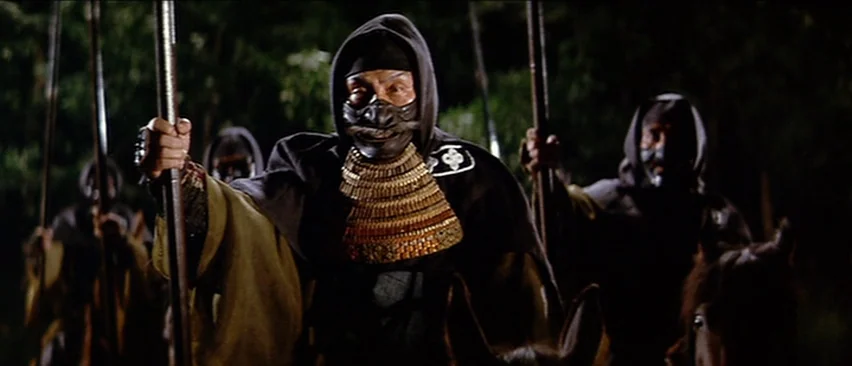 Lone Wolf and Cub: Baby Cart in the Land of Demons (1973) movie still: medium — A group of mounted warriors in dark armor travels through a wooded…