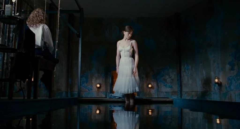 Fur: An Imaginary Portrait Of Diane Arbus (2006) movie still: wide — A dark, sparse room features a pool of water reflecting the surrounding walls.…