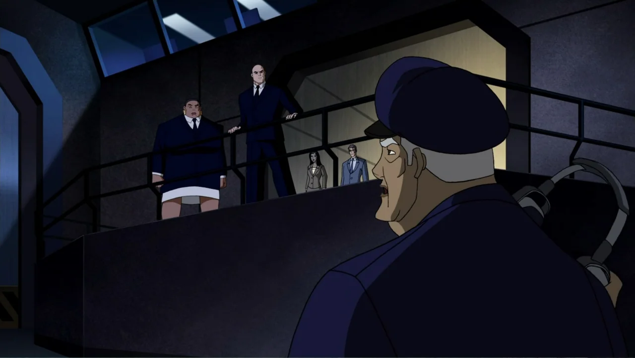 Superman/Batman: Public Enemies (2009) movie still: medium — An industrial control room features an elevated walkway and dark concrete walls. A…