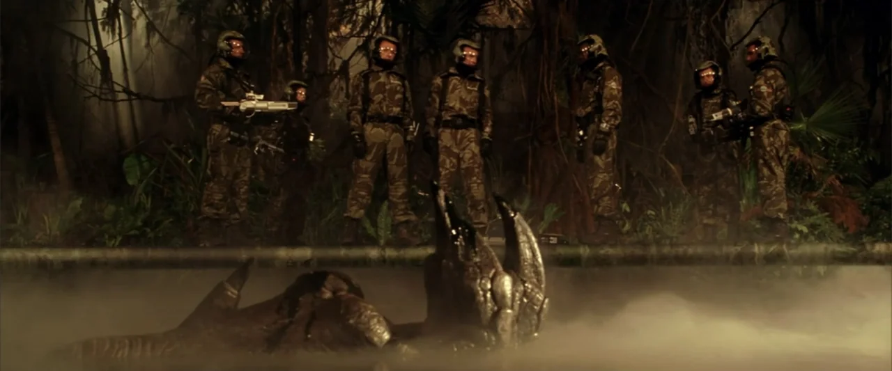A Sound of Thunder (2005) movie still: wide — A dark, fog-laden swamp filled with dense jungle vegetation at night. Six heavily armed soldiers in…