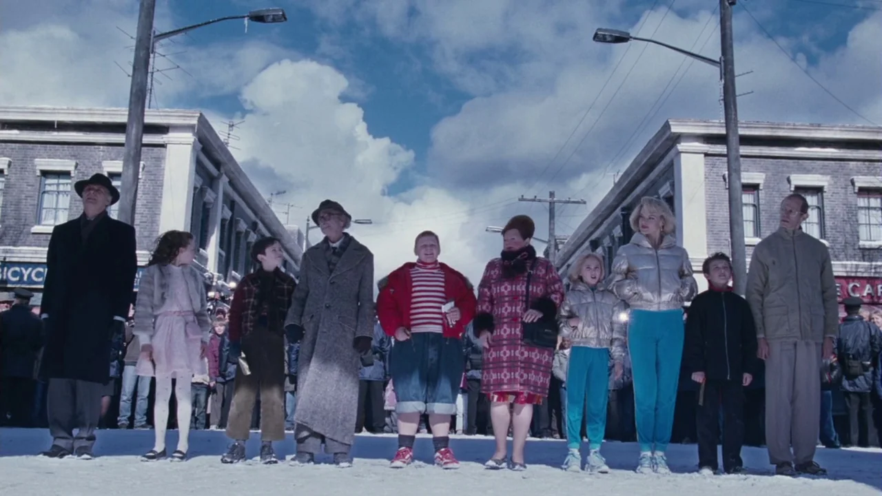 Charlie and The Chocolate Factory (2005) movie still: fullbody — A group of ten people stand in a line on a snow-covered street.