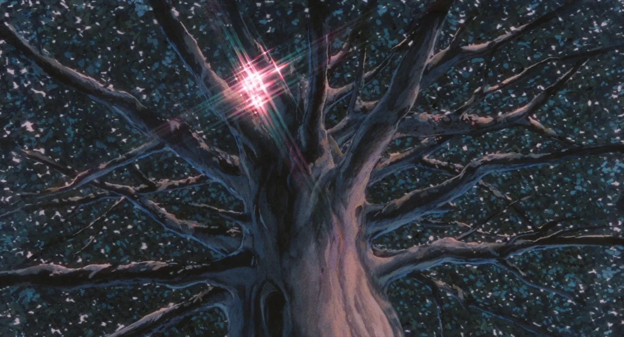 Nausicaä of the Valley of the Wind (1984) movie still: wide — A dense, dark tree canopy fills the frame at night, viewed from below. A bright…