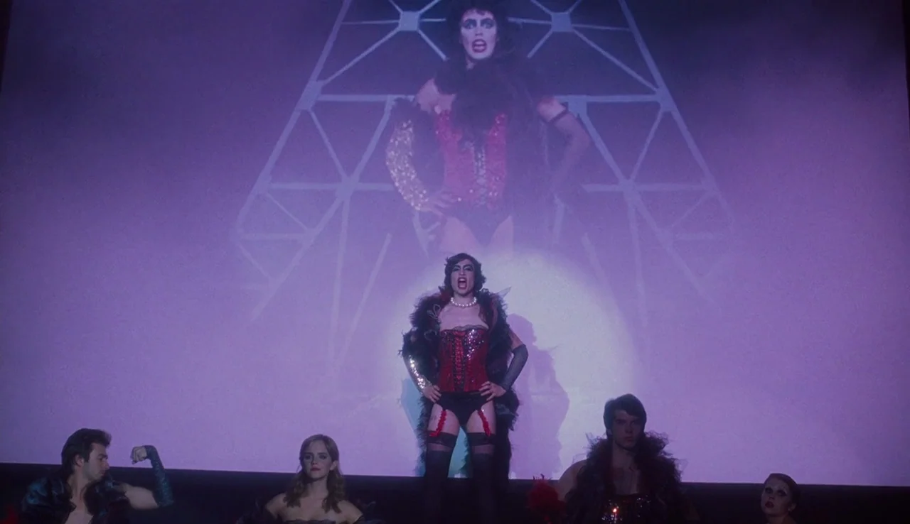 The Perks of Being A Wallflower (2012) movie still: fullbody — A group of young adults perform on a dark platform in front of a giant projection…