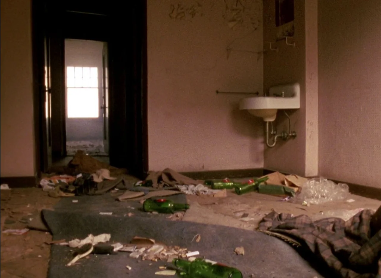 Streetwise (1984) movie still: wide — An abandoned room features a wall-mounted white sink and debris scattered across the floor. A doorway in the…