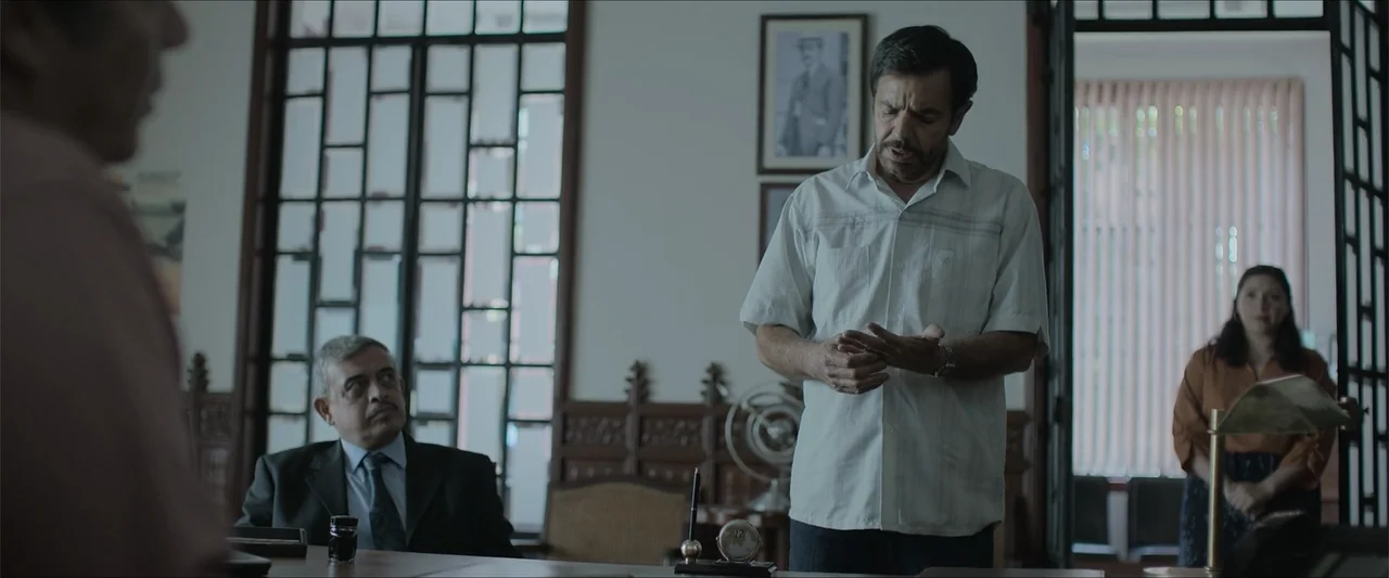 Radical (2023) movie still: medium — A quiet office contains a desk with ink and a decorative clock in front.