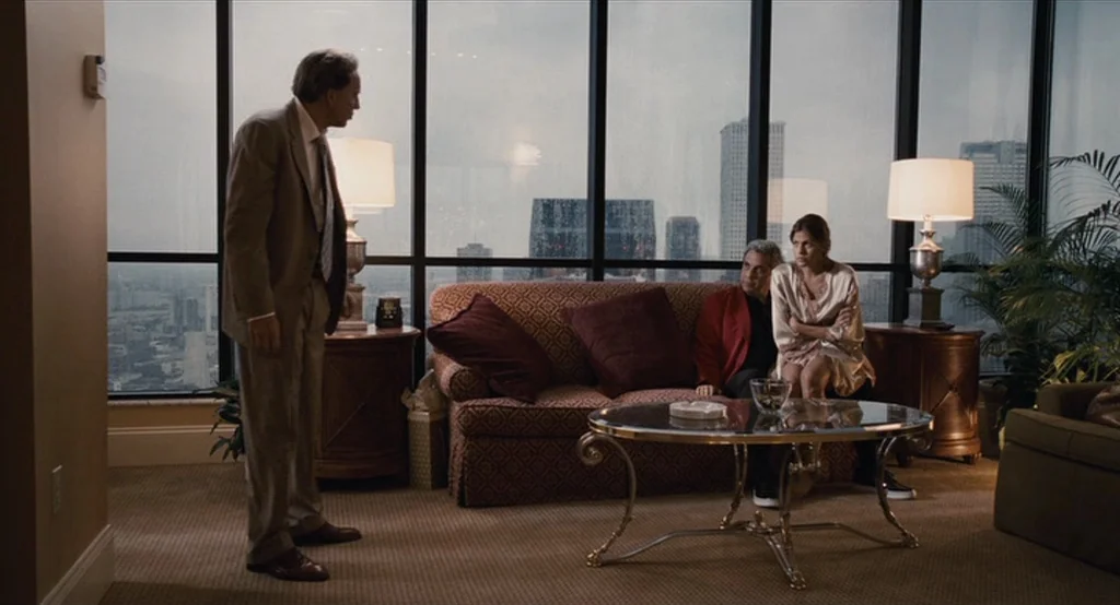 Bad Lieutenant: Port Of Call New Orleans (2009) movie still: wide — A high-rise hotel room features a large window wall overlooking a city skyline.…