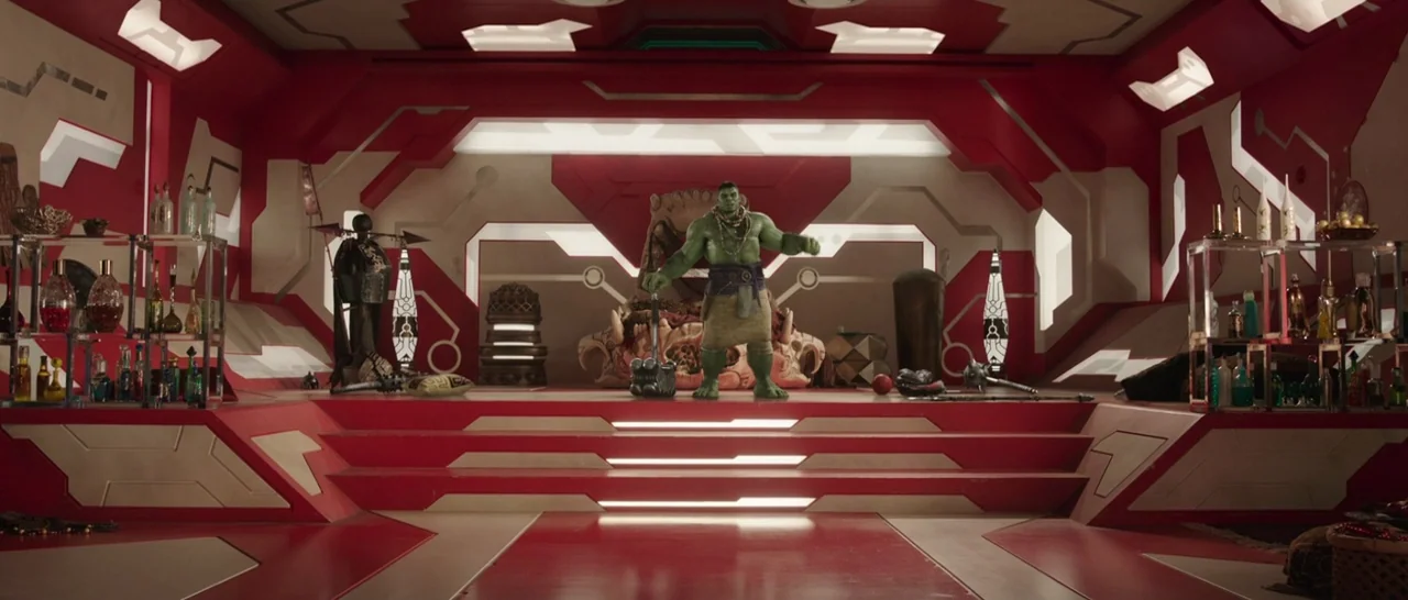 Thor: Ragnarok (2017) movie still: wide — A futuristic room features symmetrical red tiered steps leading to a large ornamental chair. A large green…