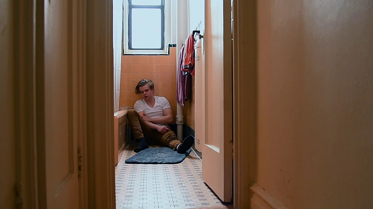We’re All Going to the World’s Fair (2021) movie still: fullbody — A tiled bathroom features pale orange wall tiles and a mosaic-patterned floor. A…