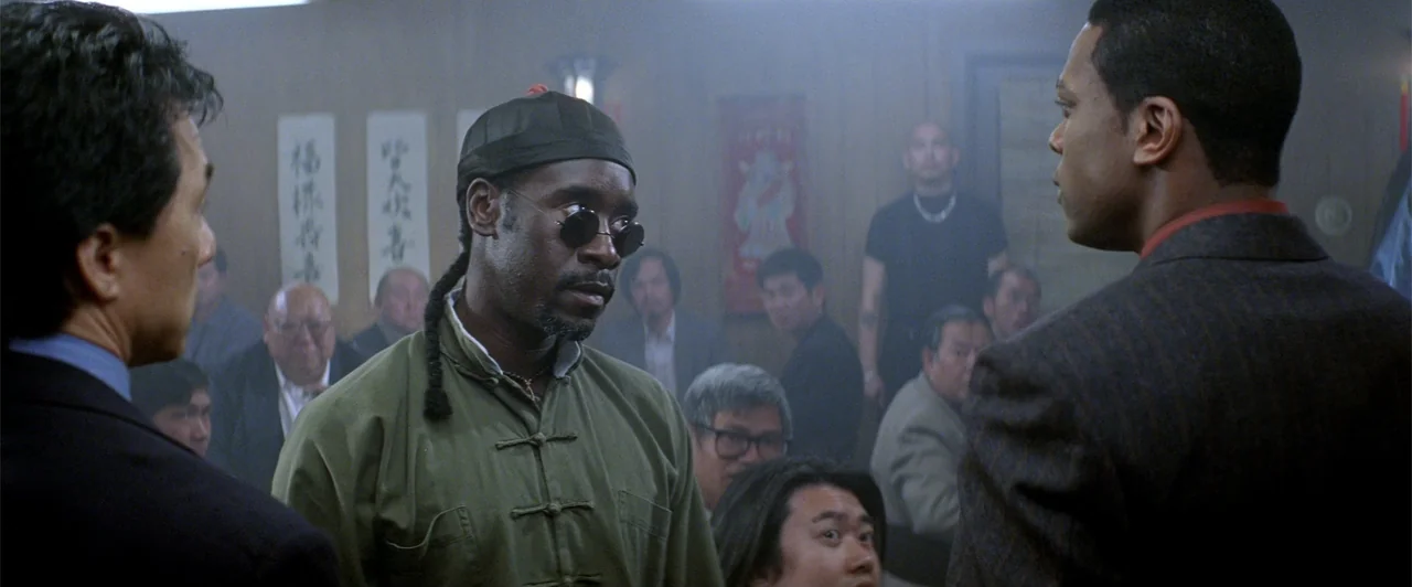 Rush Hour 2 (2001) movie still: medium — A crowded restaurant interior filled with wooden panels and numerous diners in the background. Three men…