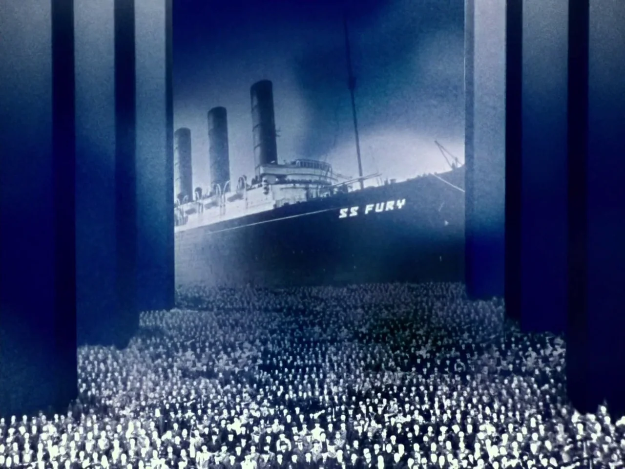 The Twentieth Century (2019) movie still: establishing — A dark night scene shows a massive ocean liner illuminated against a vast crowd. The ship…