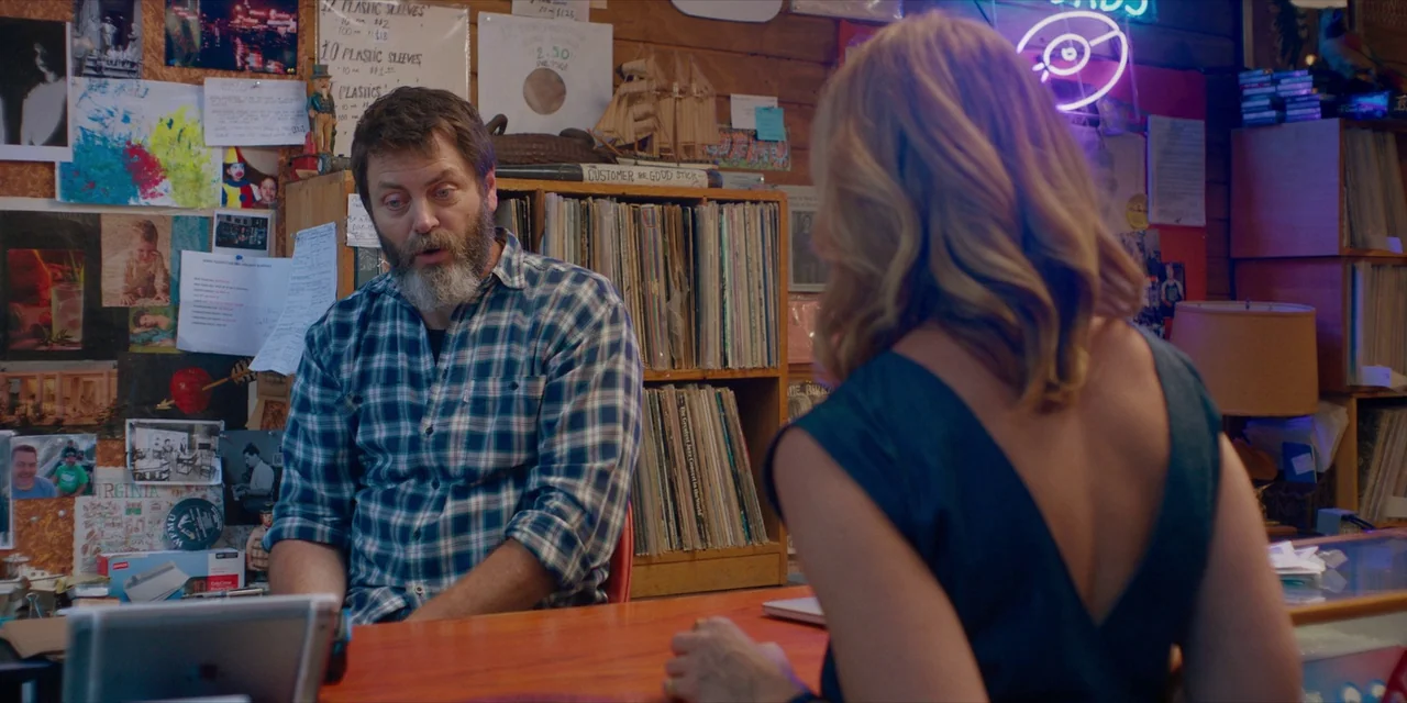 Hearts Beat Loud (2018) movie still: medium — A cluttered record shop features walls covered in photographs, flyers, and vinyl storage shelves. A…