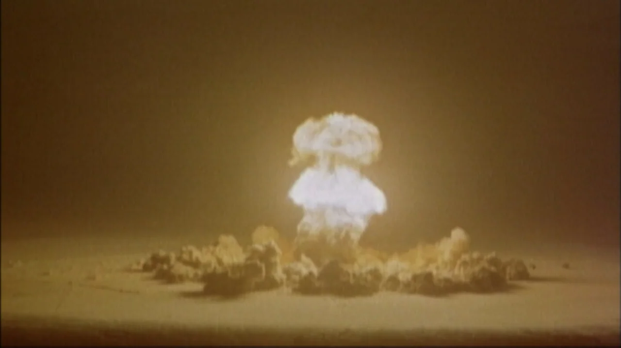 White Light/Black Rain: The Destruction of Hiroshima and Nagasaki (2007) movie still: wide — A vast, barren desert landscape stretches out under a…