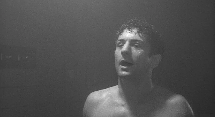 Raging Bull (1980) movie still: medium — A dark, steam-filled environment obscures the background details of the room. A shirtless, sweaty man…