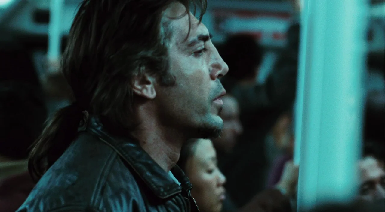 Biutiful (2010) movie still: closeup — A crowded subway train interior features passengers standing during a commute. The primary subject stands in…