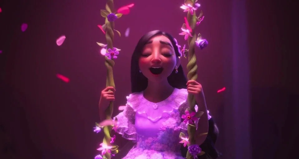 Encanto (2021) movie still: medium — A woman sits on a vine swing decorated with glowing purple and pink flowers. Glowing petals fall through the…