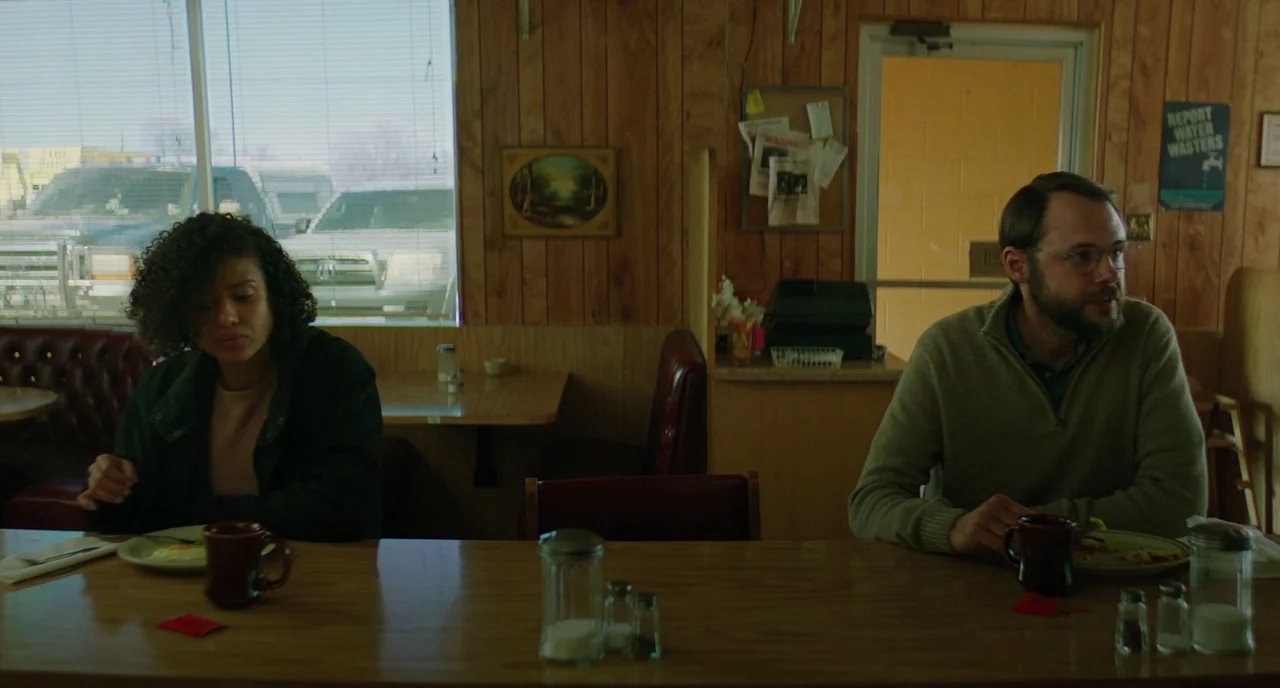 Fast Color (2018) movie still: medium — A wood-paneled diner booth features a window with blinds and rustic decor. A man and woman sit at the table…