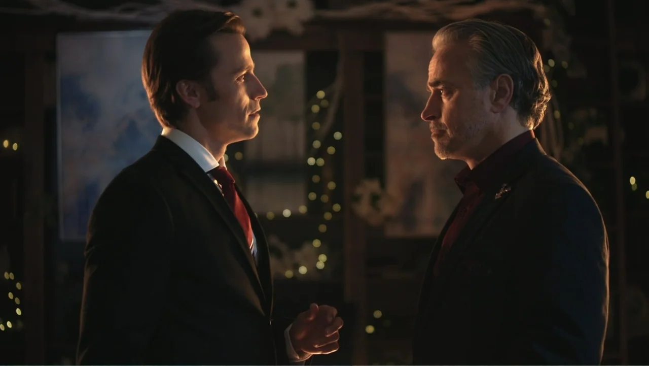Driving Madeleine (2022) movie still: medium — A dark interior space features a blurred background with faint warm glowing fairy lights. Two men in…