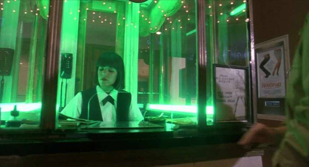 A Nightmare On Elm Street 4: The Dream Master (1988) movie still: medium — A small glass-enclosed ticket booth is illuminated by a green light…