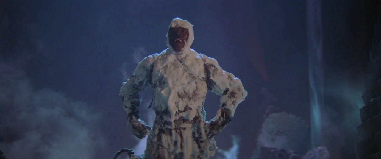 Ghostbusters (1984) movie still: fullbody — A dark environment filled with thick swirling mist in a studio setting. A man is covered entirely in…