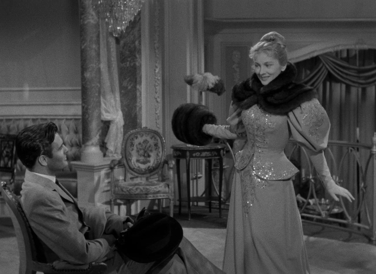 Letter From An Unknown Woman (1948) movie still: fullbody — A luxuriously decorated parlor features ornate architectural columns and a grand crystal…