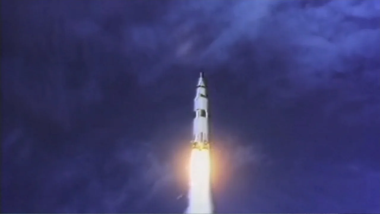 UFO Conspiracies: The Hidden Truth (2020) movie still: wide — A massive multi-stage rocket lifts off from a launch site into the night sky. The…