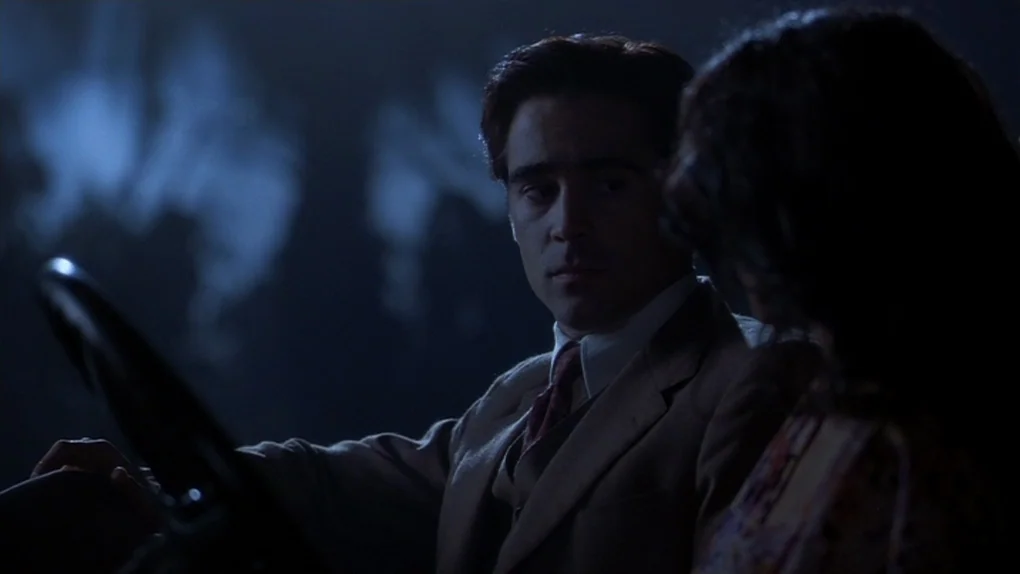 Ask The Dust (2006) movie still: medium — The interior of a vintage car at night is bathed in cool moonlight. A man in a tan suit sits behind the…