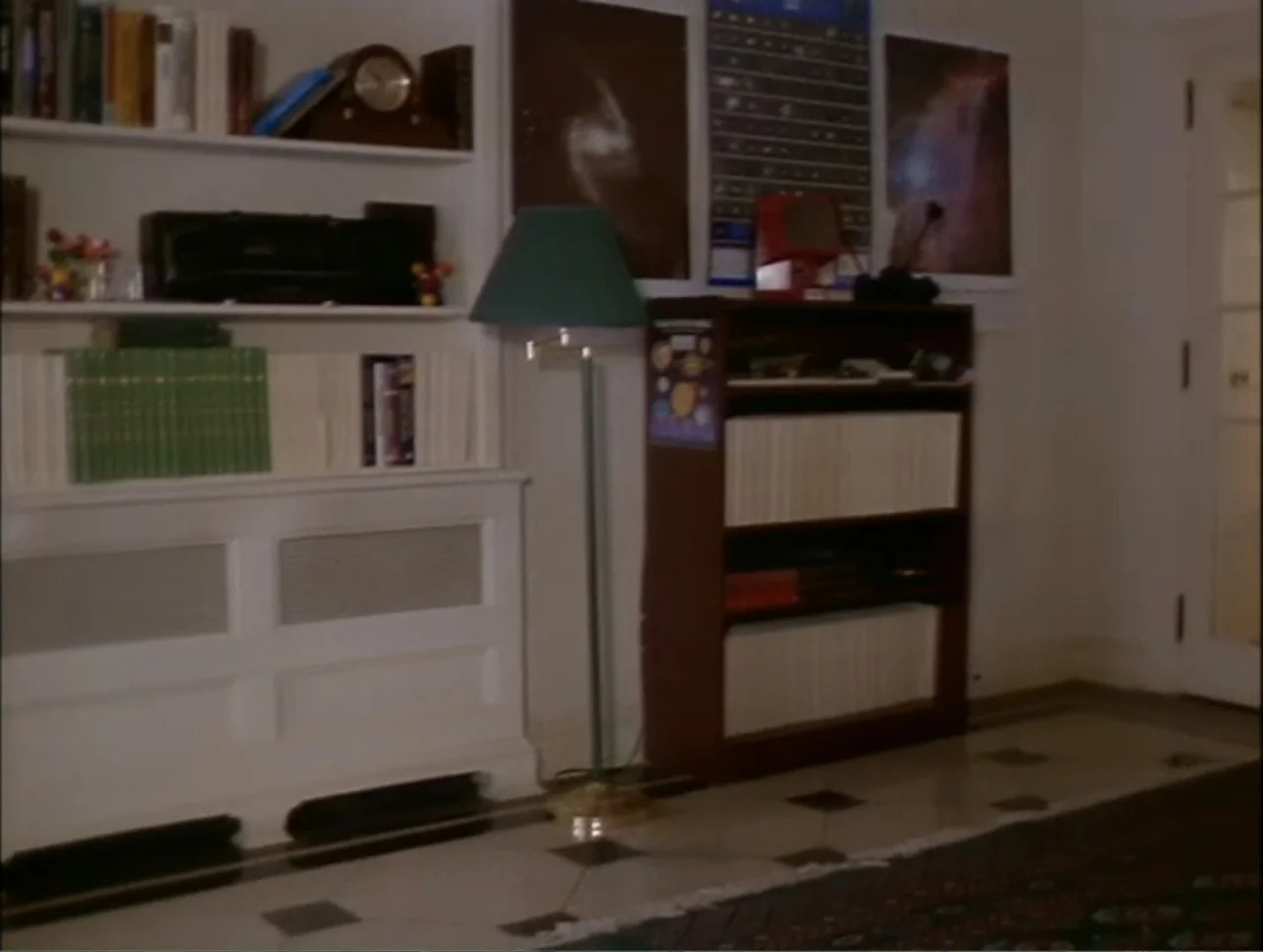 At the Midnight Hour (1995) movie still: wide — A residential room features built-in white shelving, dark wooden bookcases, and patterned floor…